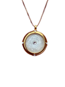 Gold pendant necklace with a white stone on a white background
