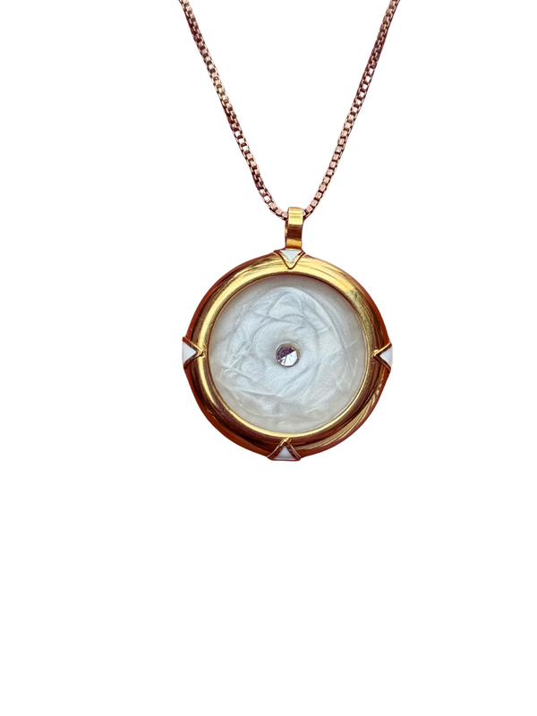 Gold pendant necklace with a white stone on a white background